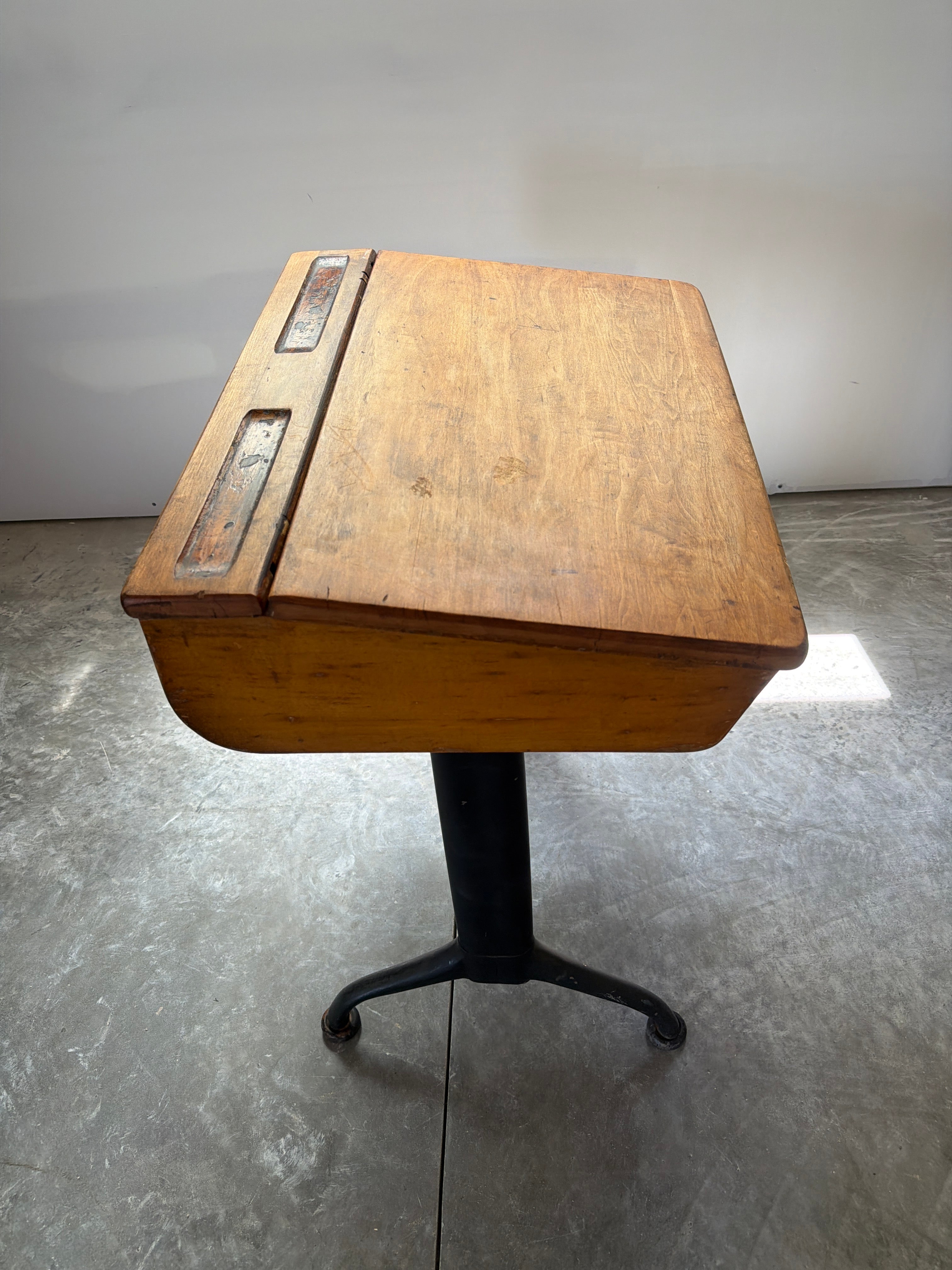 Vintage lift-top school desk with hardwood cabinet and industrial steel pedestal base
